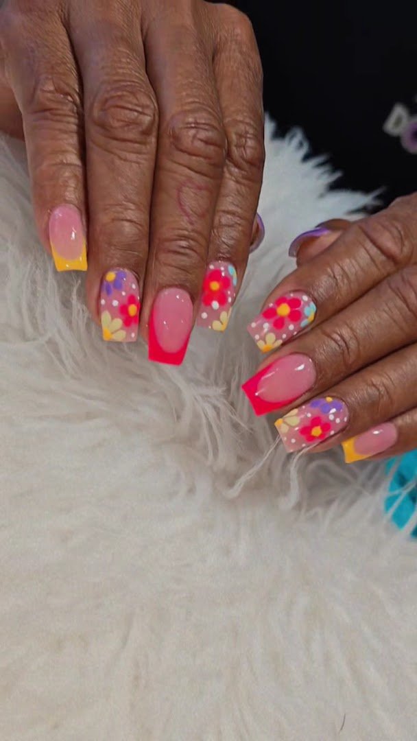 Nail technician shaping acrylic nails.